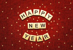 happy new year spelled with scrabbles on a red background