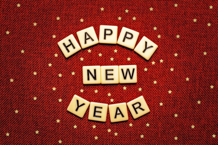 happy new year spelled with scrabbles on a red background