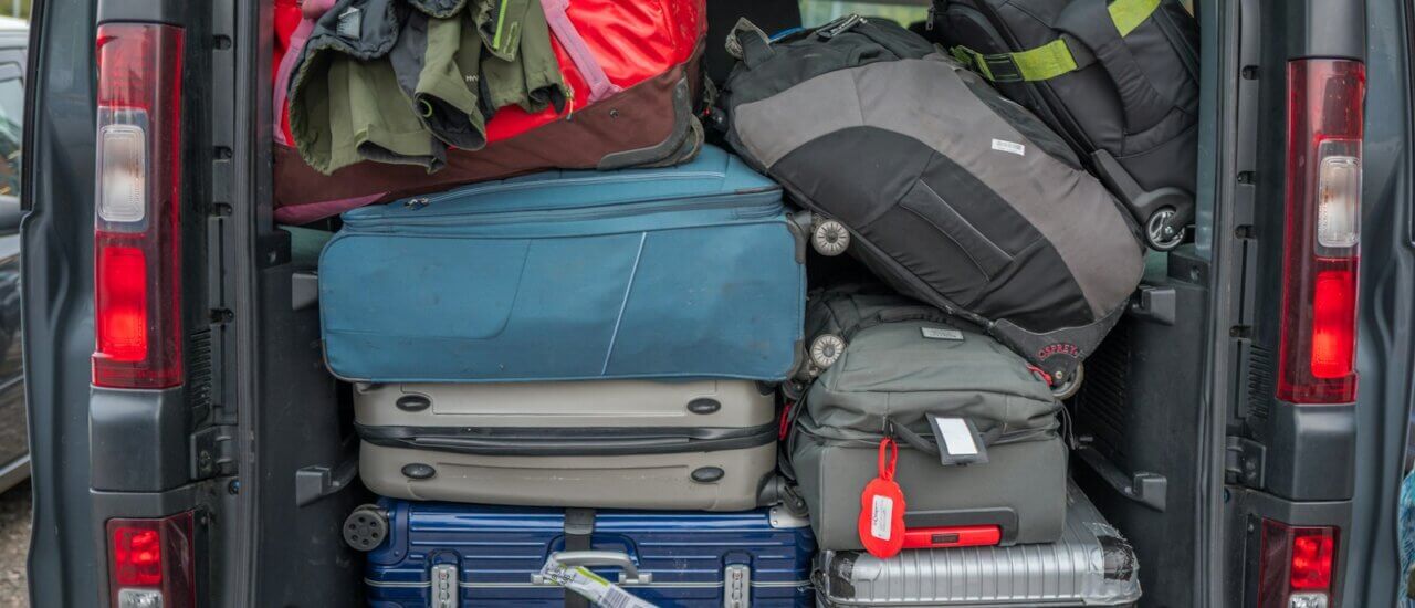 Van packed full with luggage for a trip.